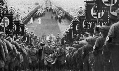 hitler-walking-up-steps-at-nazi-rally