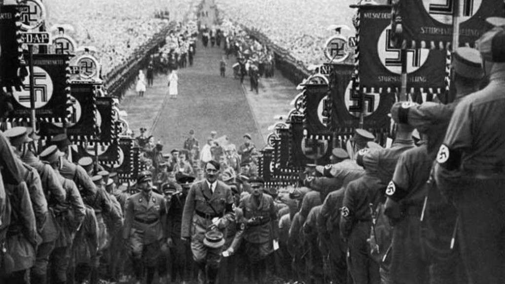 hitler-walking-up-steps-at-nazi-rally